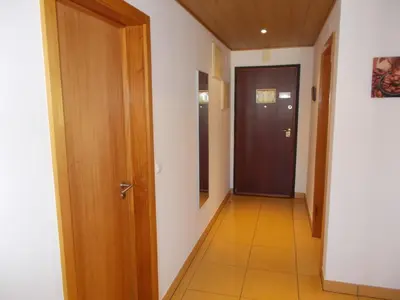 a hallway with a door and a tiled floor at T1 e T2 Marina Albufeira apartments in Albufeira