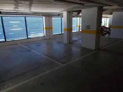 an empty room with yellow and white pillars in a building at T1 e T2 Marina Albufeira apartments in Albufeira