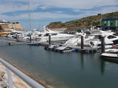 a bunch of boats are docked in a marina at T1 e T2 Marina Albufeira apartments in Albufeira