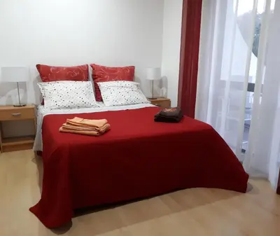 a bedroom with a bed with a red blanket at 5 Minutes Walk from the Beach in Albufeira