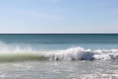 a wave in the ocean on the beach at 5 Minutes Walk from the Beach in Albufeira