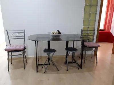 a dining room table with three chairs and a bowl on it at 5 Minutes Walk from the Beach in Albufeira