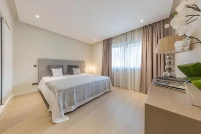 a bedroom with a bed and a large window at NOA Apartment Quinta do Lago in Quinta do Lago