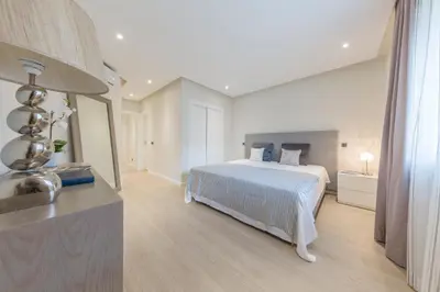 a large white bedroom with a bed and a window at NOA Apartment Quinta do Lago in Quinta do Lago