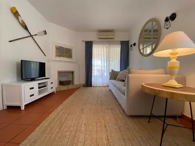 a living room with a couch and a television at Quinta do Lago Golf in Quinta do Lago