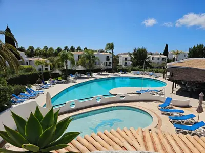 a large swimming pool with lounge chairs and a resort at São Rafael Golden Pearl Haven in Albufeira