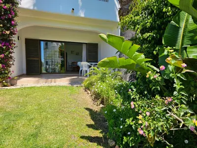 a house with a yard with flowers and plants at São Rafael Golden Pearl Haven in Albufeira