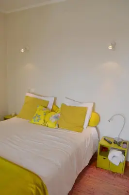 a bedroom with a white bed with yellow pillows at TP Coral 1 - Marina Vilamoura Apartment in Vilamoura