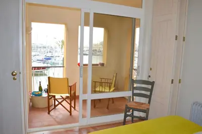 a bedroom with a balcony with a table and chairs at TP Coral 1 - Marina Vilamoura Apartment in Vilamoura