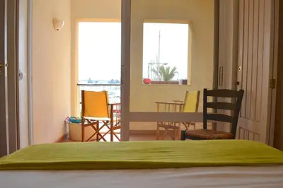a bedroom with a bed and a table and chairs at TP Coral 1 - Marina Vilamoura Apartment in Vilamoura