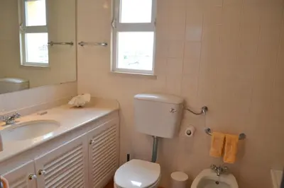 a bathroom with a toilet and a sink and a mirror at TP Coral 1 - Marina Vilamoura Apartment in Vilamoura