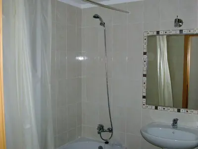 a bathroom with a shower and a sink and a mirror at Jazzy Cool Apartment Near White Sand Beaches in Albufeira