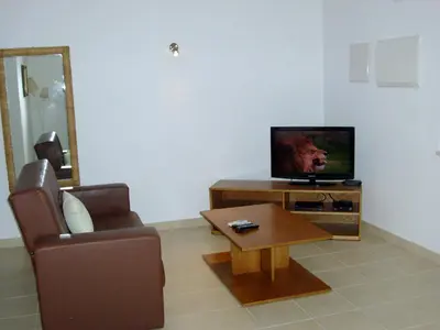 a living room with a couch and a television at Jazzy Cool Apartment Near White Sand Beaches in Albufeira
