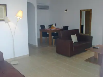 a living room with a couch and a table at Jazzy Cool Apartment Near White Sand Beaches in Albufeira
