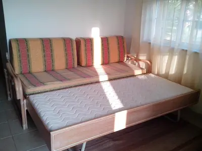 a bed sitting in a room next to a window at Deluxe Apartment E in Albufeira