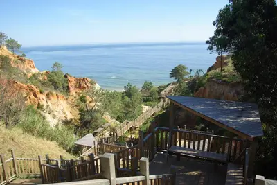a set of stairs leading down a hill to the ocean at Deluxe Apartment H in Albufeira