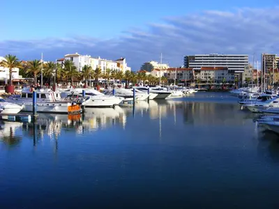 a group of boats docked in a marina with buildings at Iconic Apartment with 2 Bedrooms in Albufeira