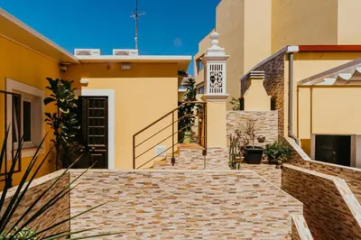 a set of stairs leading up to a house at Happy House in Faro