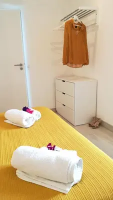 two towels sitting on a bed in a bedroom at Golden Cliff House in Albufeira