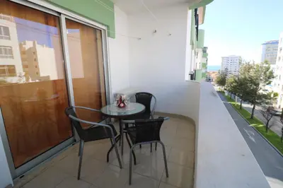 a table and chairs on the balcony of a building at Alsol in Quarteira