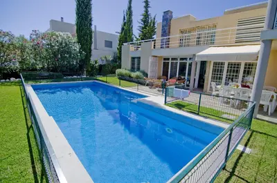 a swimming pool in the backyard of a house at Villa Lake View in Quarteira