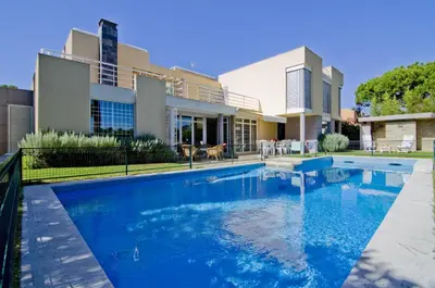 a swimming pool in front of a house at Villa Lake View in Quarteira
