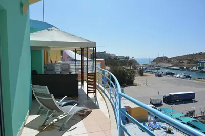 a balcony with chairs and a view of a harbor at Penthouse Marina in Albufeira