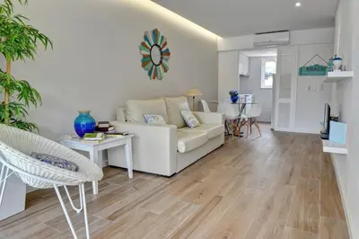 a living room with a white couch and a table at 3 Villas - Praia da Falesia in Albufeira
