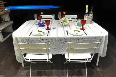 a white table with two chairs and wine glasses at 3 Villas - Praia da Falesia in Albufeira