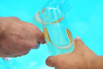 a man is holding a glass with a spoon at 3 Villas - Praia da Falesia in Albufeira