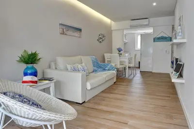 a living room with a couch and chairs and a table at 3 Villas - Praia da Falesia in Albufeira
