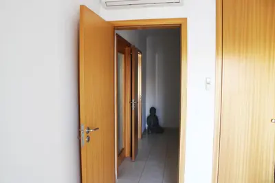 a hallway with an open door and a dog sitting in a room at Apartment with terrace Albufeira Olhos de Água in Albufeira