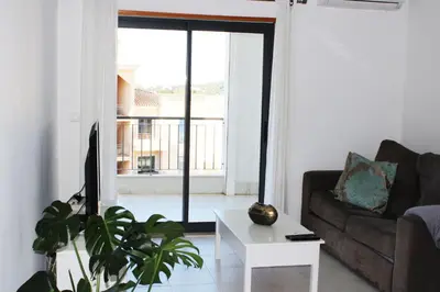 a living room with a couch and a table at Apartment with terrace Albufeira Olhos de Água in Albufeira