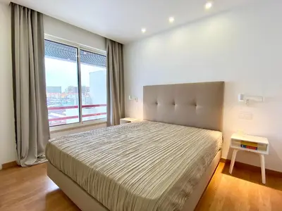 a bedroom with a large bed and a large window at Home Out Luxury Marina Apartment - 2 Bedrooms Sea View in Vilamoura