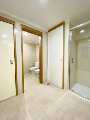 a bathroom with a toilet and a glass door at Home Out Luxury Marina Apartment - 2 Bedrooms Sea View in Vilamoura