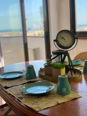 a table with plates and a clock on top of it at Algarve Vacations Flat in Albufeira