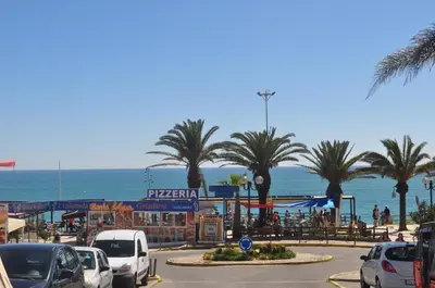 a parking lot with cars parked on the beach at Algarve Vacations Flat in Albufeira