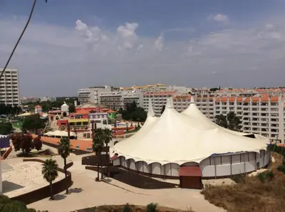 a large white tent in a city with buildings at Algarve Vacations Flat in Albufeira