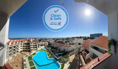 a sign for the clean and safe swimming pool at a resort at Algarve Vacations Flat in Albufeira