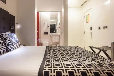 a bedroom with a large bed and a bathroom at Faro Boutique Hotel in Faro