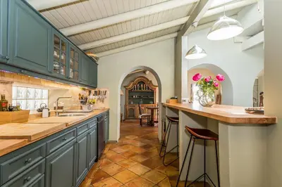 a large kitchen with blue cabinets and a counter at FLH Belaventura Villa in Boliqueime