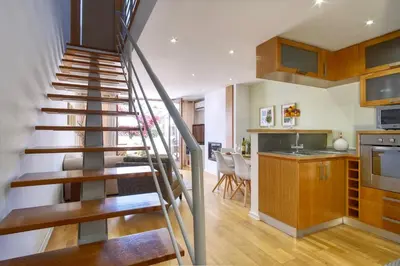 a staircase leading to a kitchen and a living room at Casa da Avó in Faro