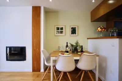 a kitchen with a dining room table and chairs at Casa da Avó in Faro