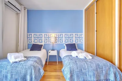 two beds with towels on them in a room at Casa da Avó in Faro