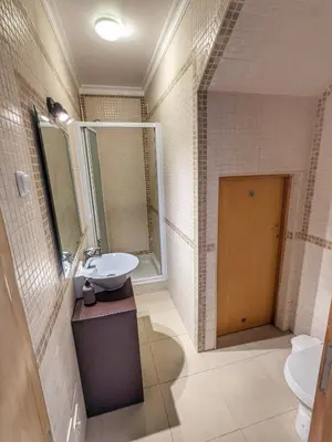 a bathroom with a sink and a mirror at Farm Village- Townhouse 2 mins from Old Town Albufeira in Albufeira