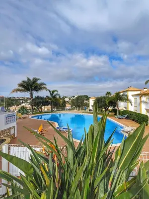 a view of the pool from the balcony of a resort at Farm Village- Townhouse 2 mins from Old Town Albufeira in Albufeira
