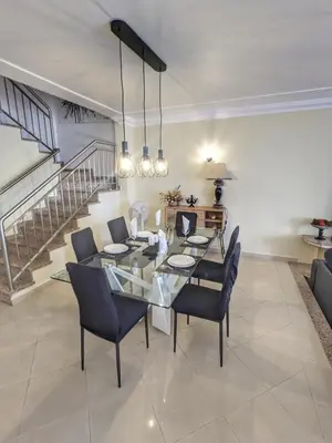 a dining room with a glass table and chairs at Farm Village- Townhouse 2 mins from Old Town Albufeira in Albufeira
