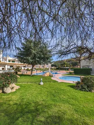a park with a swimming pool and a tree at Townhouse 700m from Sao Rafael Beach in Albufeira