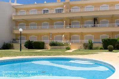 a building with a swimming pool in front of a building at Akisol Vilamoura Sun III in Vilamoura