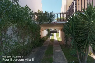 an alley way with a bridge and a plant at Akivillas Quarteira Rose in Quarteira